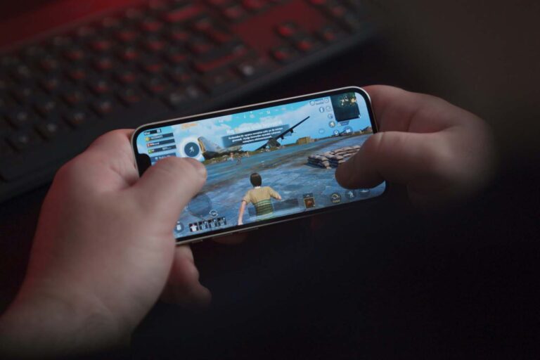 Person playing PUBG mobile by onurbinay Unsplash